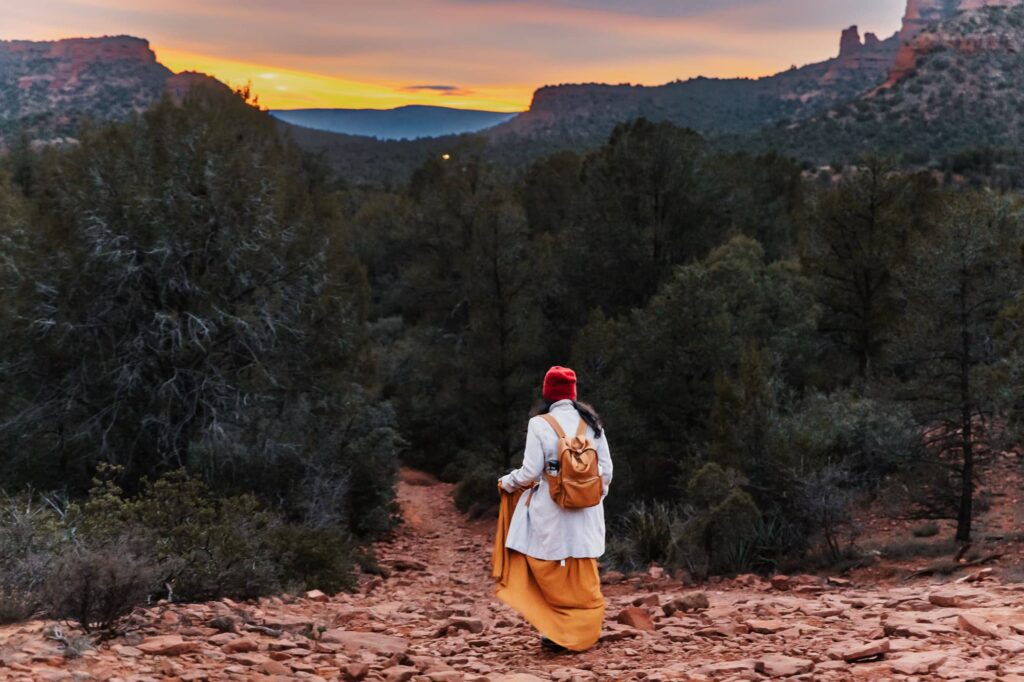 10 Tips to plan an eco-friendly elopement or intimate wedding, which is not only good for the environment but can also be a way to express your values and create a unique and meaningful celebration. This is a shot of the bride hiking at Sedona before her elopement.