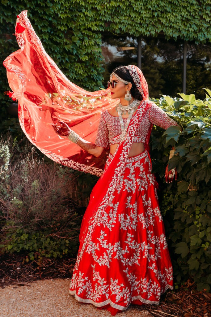 A photo of a bride embracing cultural diversity. She incorporated traditions of her heritage into her elopement day by choosing to wear her Indian ethnic wear (lehenga). Here's a Comprehensive Guide to Incorporating Traditions into Your Elopement Day.
